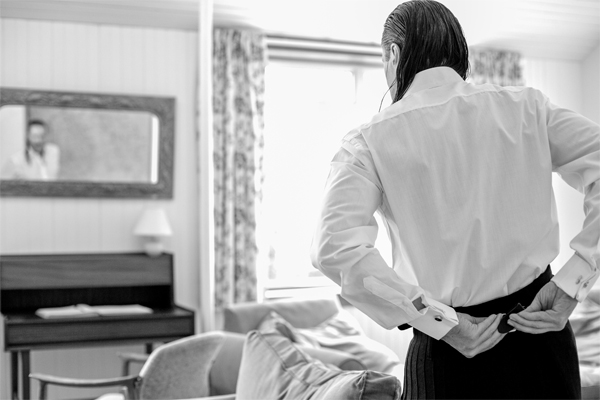 groom fixing his kilt during preparations