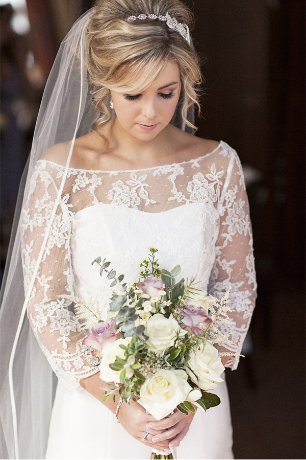 bride looking at her flowers at stonefield castle