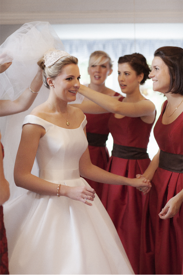 bridesmates helping to fix bride