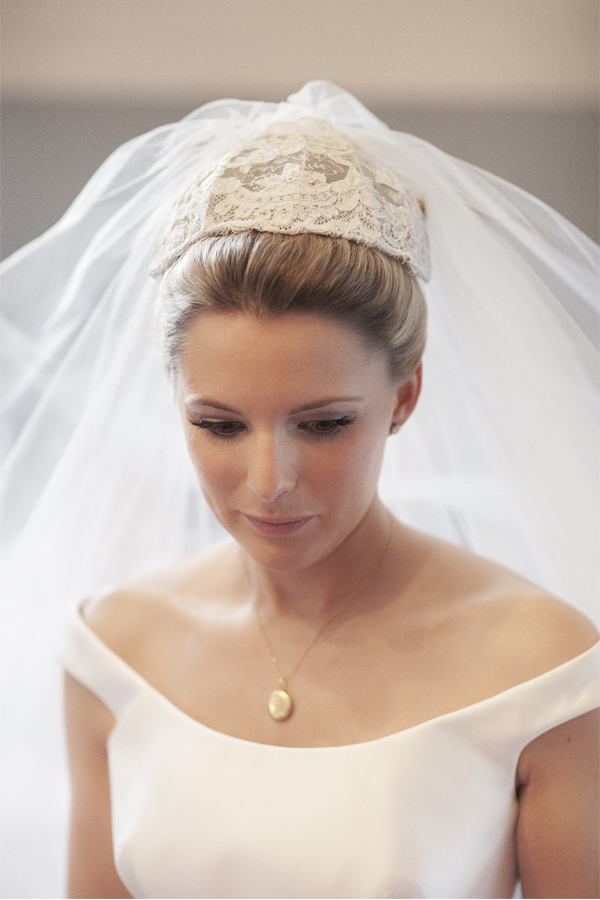 bride looking down having her veil fixed