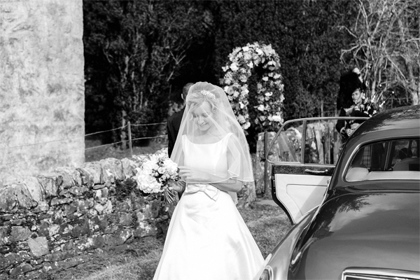 bride walking towards church at wedding