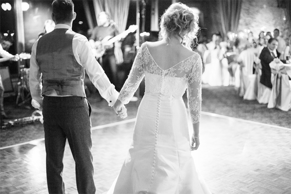 bride and groom walking in into their wedding first dance