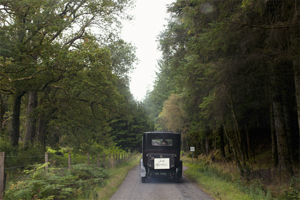 newlyweds leaving in a vintage car