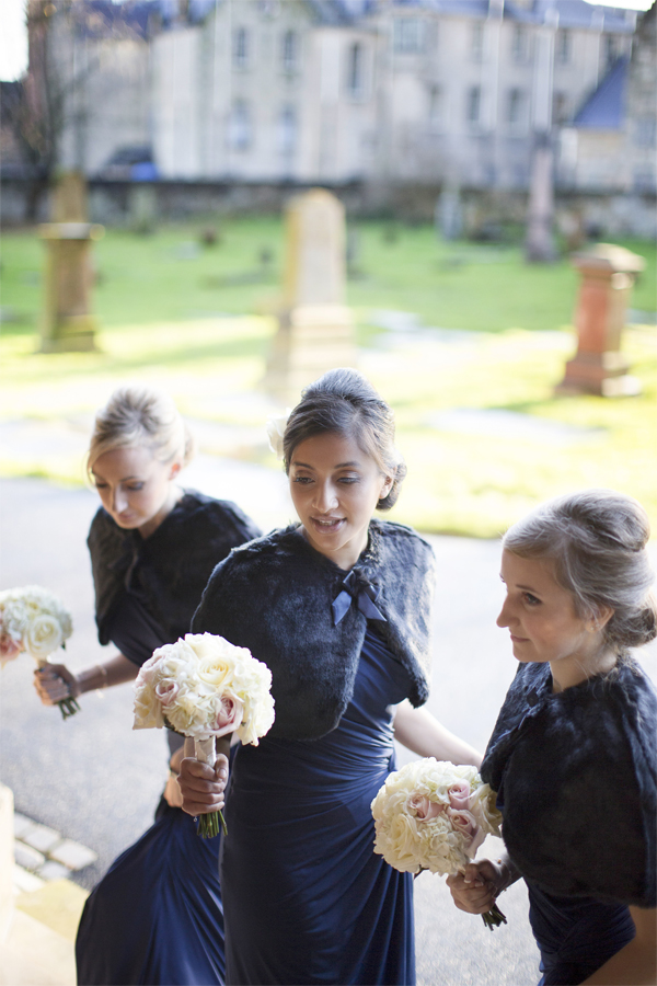 bridemsates going into teh church wearing navy blue dresses