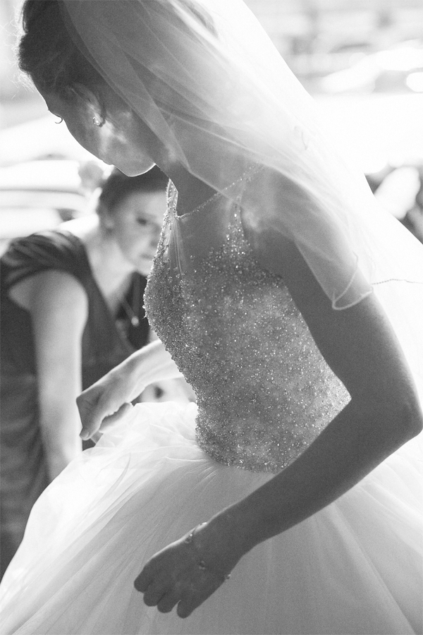 bride having her dress fixed 