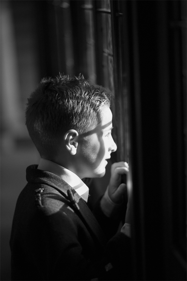boy looking at bride through a window