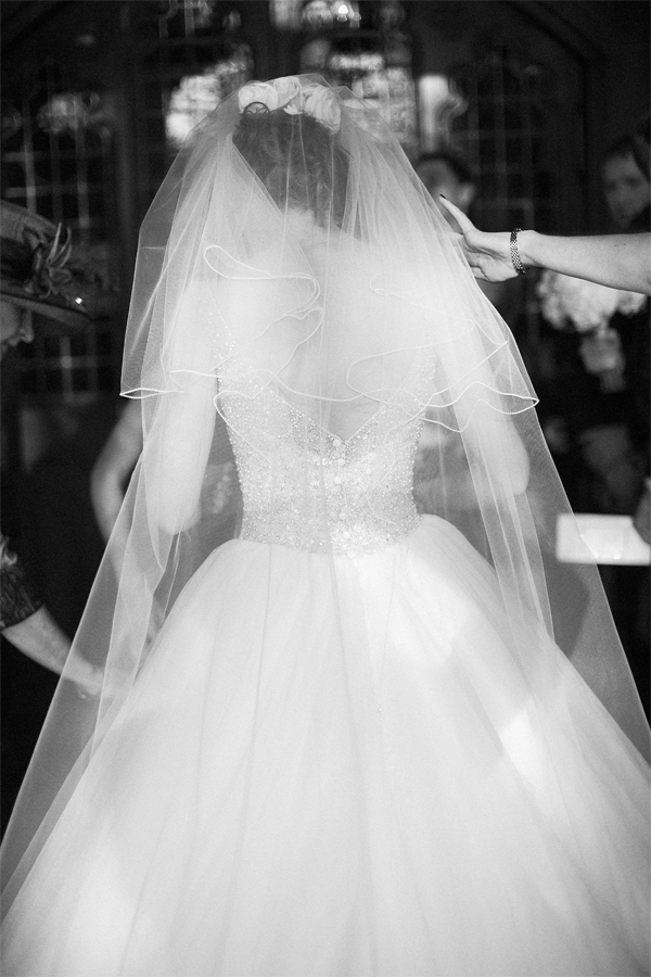 girls fixing brides dress just before ceremony