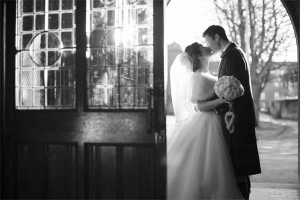 newlyweds kissing embraced