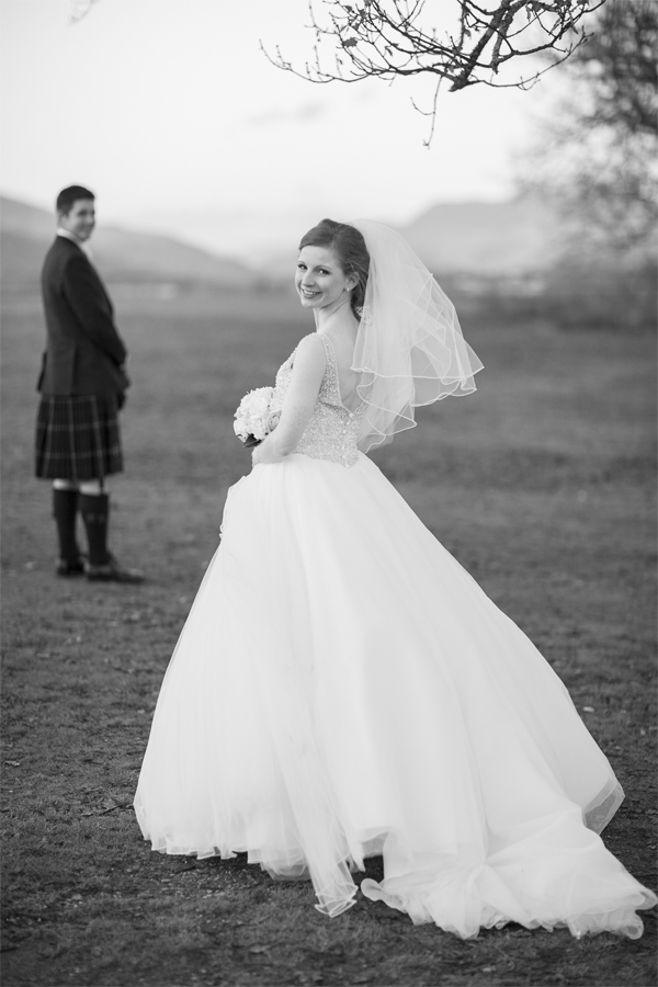 bride and groom standing at loch lomond