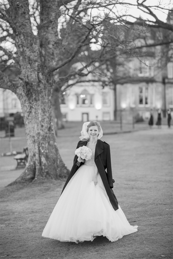 bride in a winter coat during wedding photo shoot