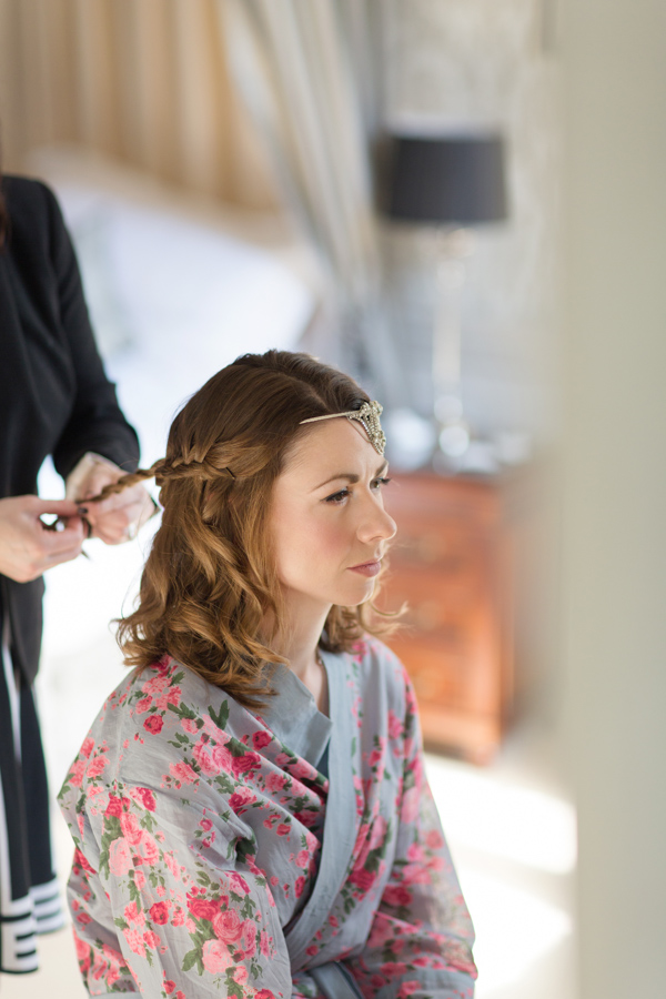 bride having her hair done and hair piece installed