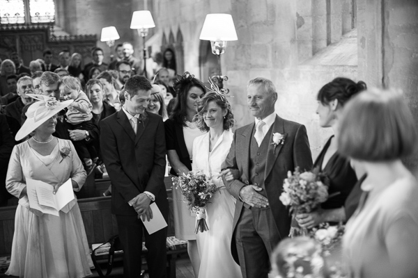 bride walking down to church ceremony