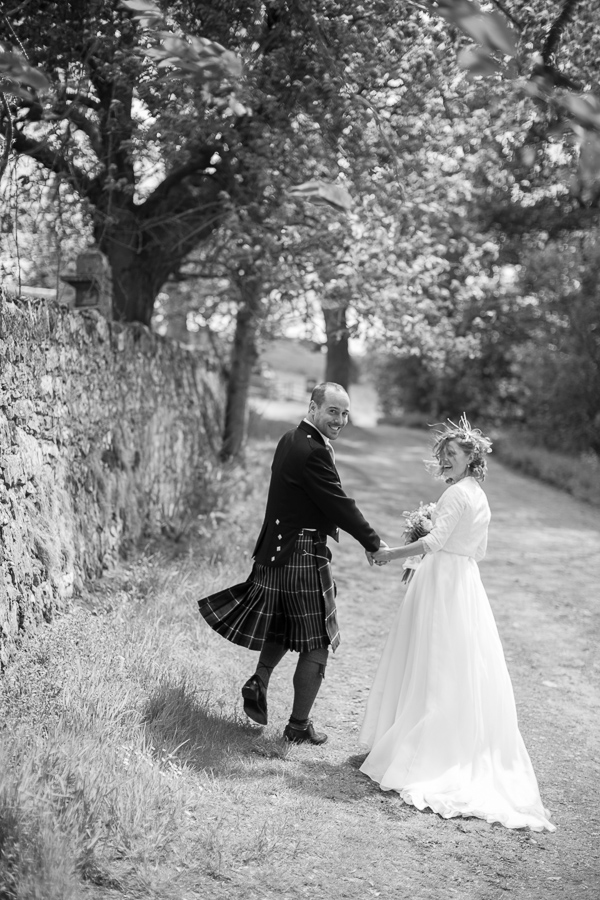 bride and groom walking away together