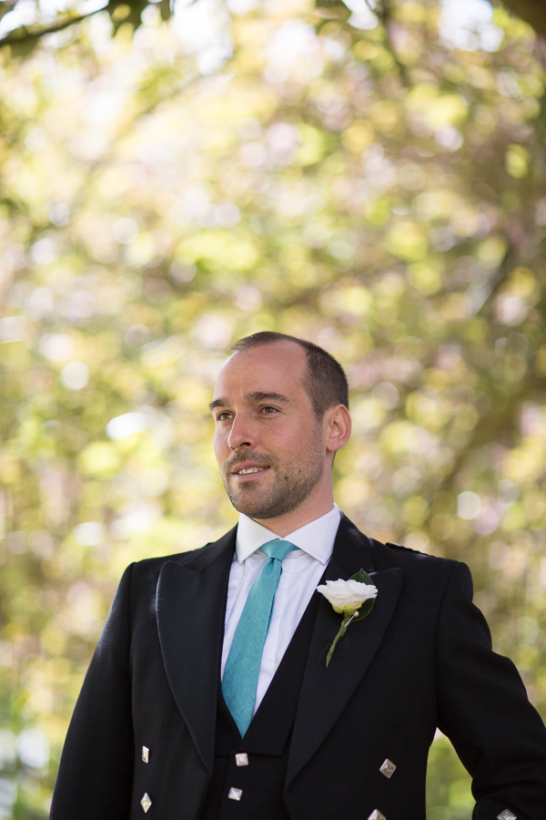 groom looking away with flower botton hole