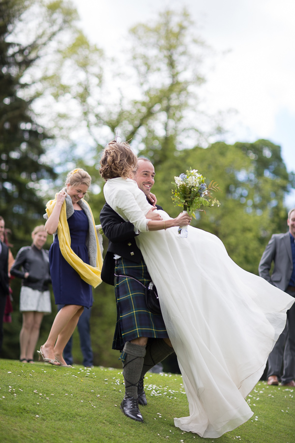 wedding photographer edinburgh scotland groom lifting bride