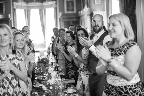 guests clapping looking at bride and groom