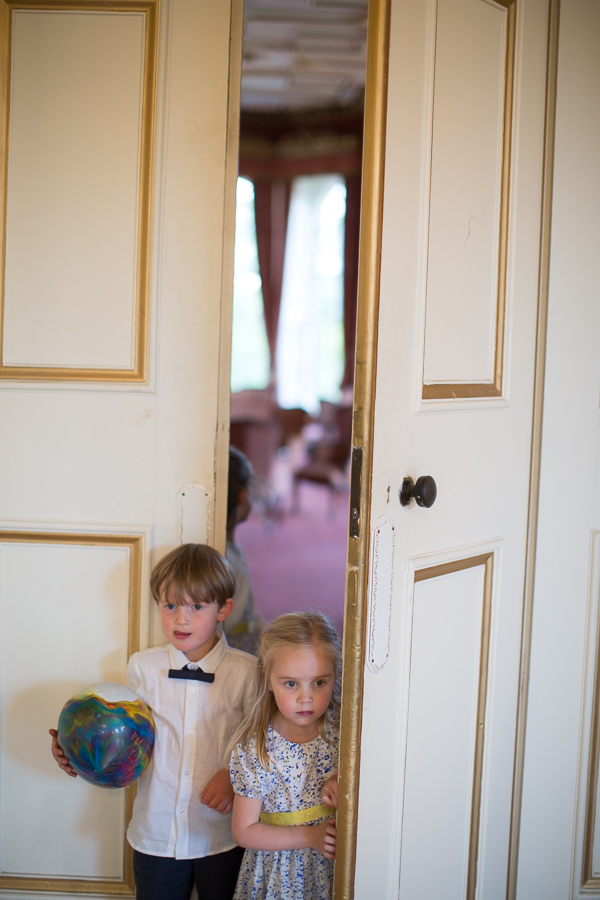 kids looking in from behoind closed doors