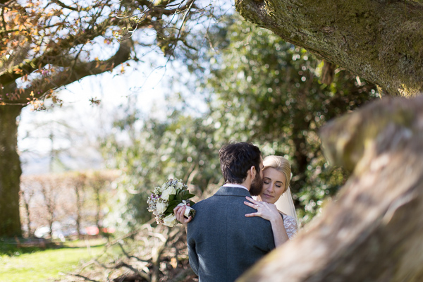 bride and groom embraced in the garden 