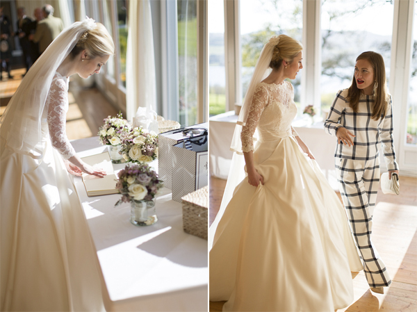 bride looking at her guest book and talking to guest