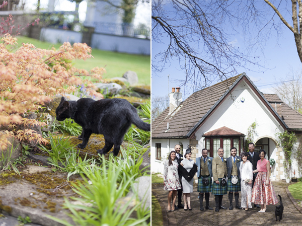 family photo infornt of a house with cat