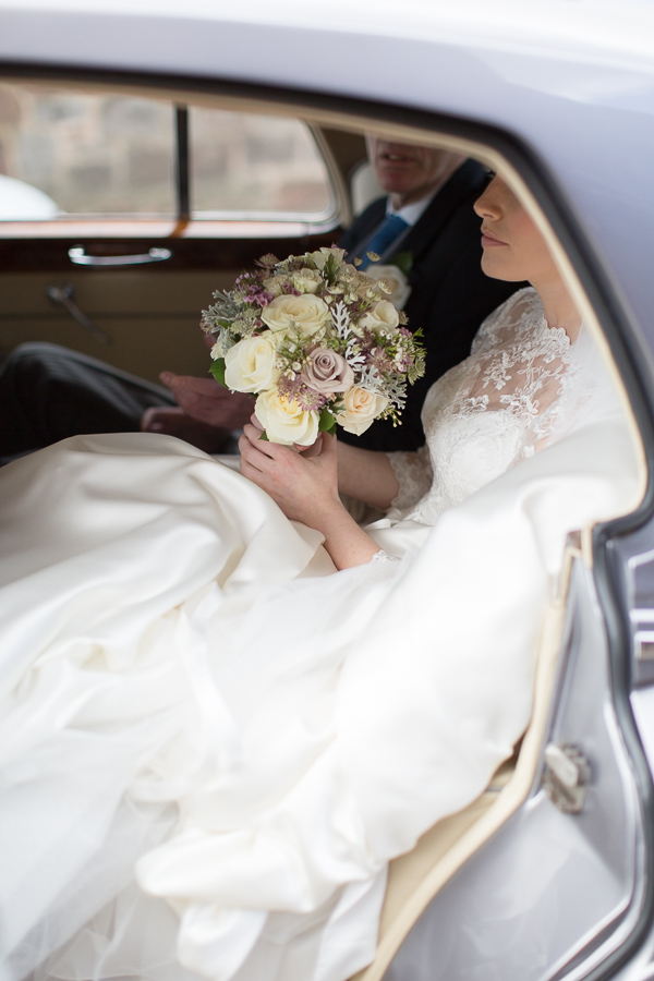 bride and father insdie the wedding car at church ceremony