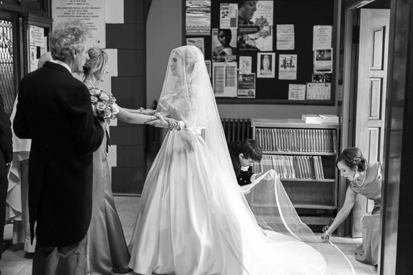 bride holding hands with bridesmate just before ceremony