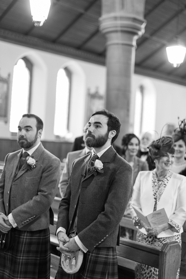 groom and best man wainting inside the church 