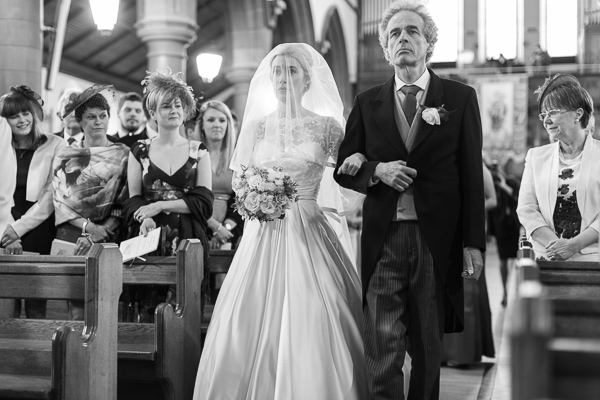 bride walking down at a large church ceremony