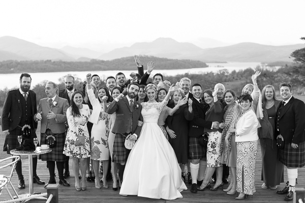 bride and groom with guests outside