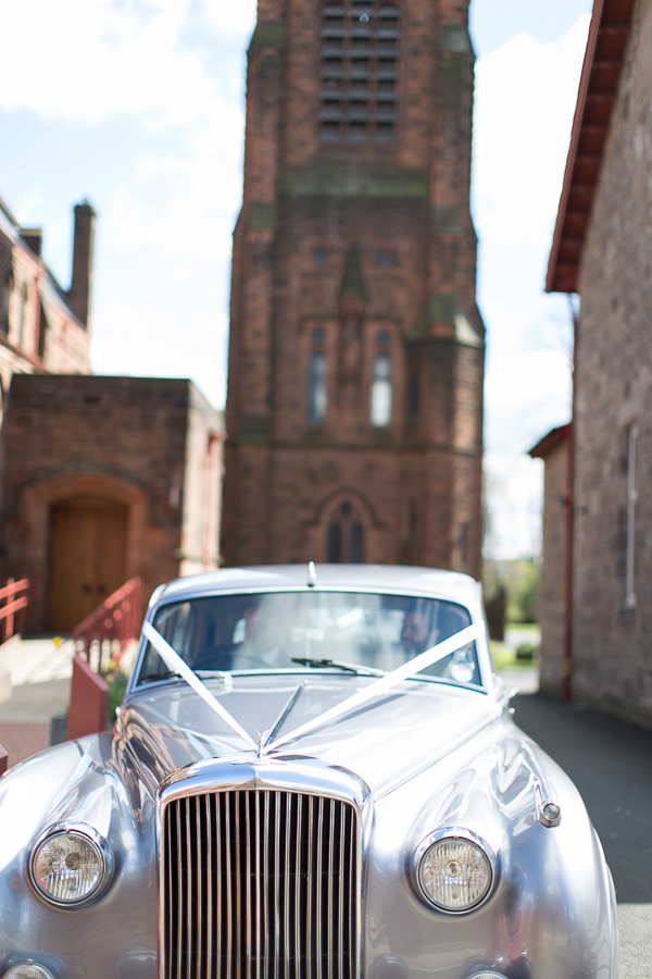 wedding car leaving the church