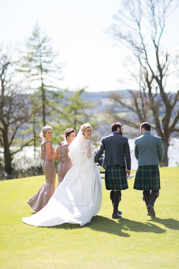 bridal party walking away with loch lomond in the distance
