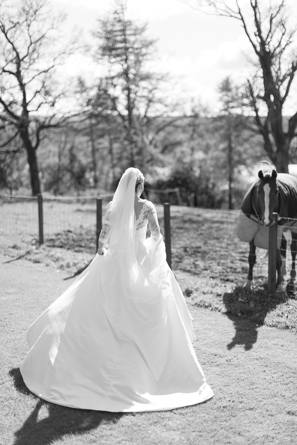 bride walking closer to a horse at boturich castle on loch lomond wedding