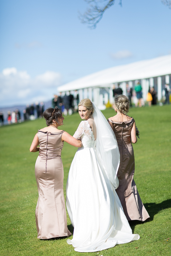 bride walking away with bridesmates
