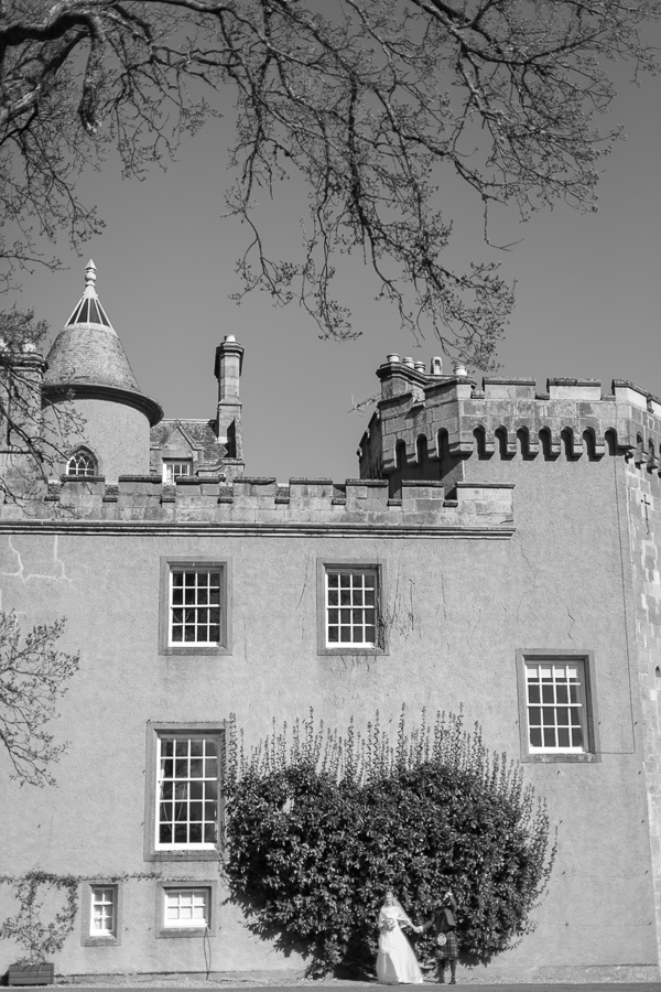 boturich castle wedding bride and groom standing next to castle photos by fotogenic of scotland