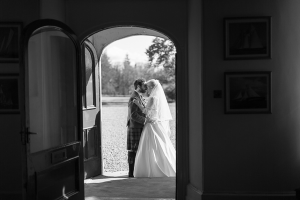 bride and groom kissing at Boturich Castle Wedding