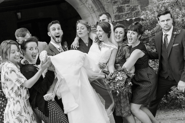 bride beeing lifted by groom and friends