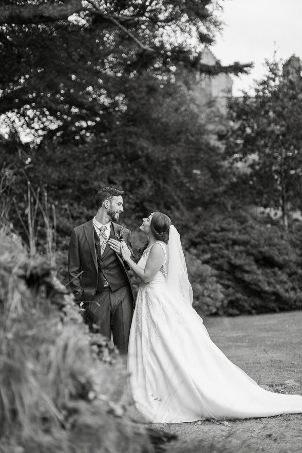 wedding photos of newlyweds looking at each other in ardkinglas garden