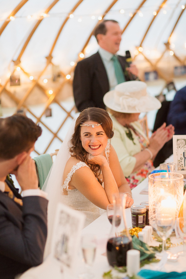 bride smiling to groom during father