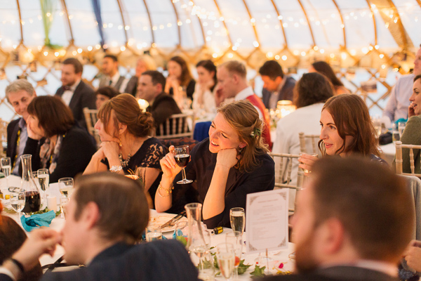 wedding guests during speeches in tipi tent