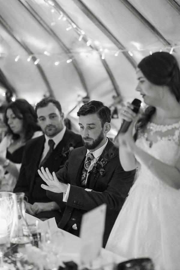 wedding photos glasgow, groom looking at his ring during speeches