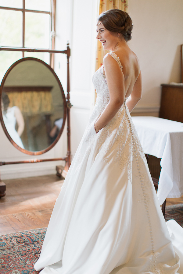 bride laughing with her hands in pockets weddign dress