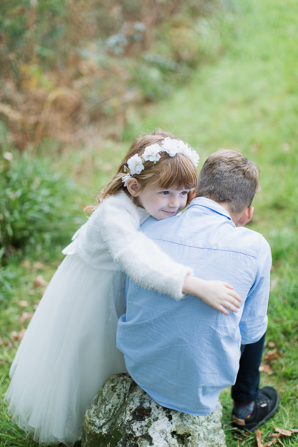 flower girl huging his brother before ceremony