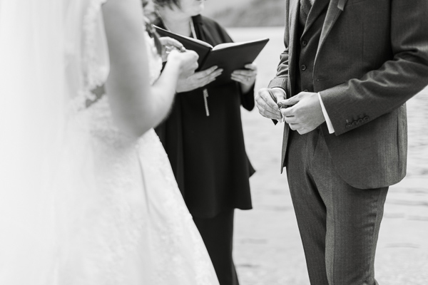 groom holding weddig ring during ceremony