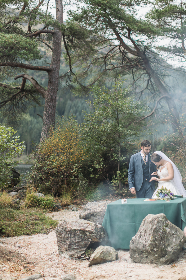 bride and groom looking at their wedding rings