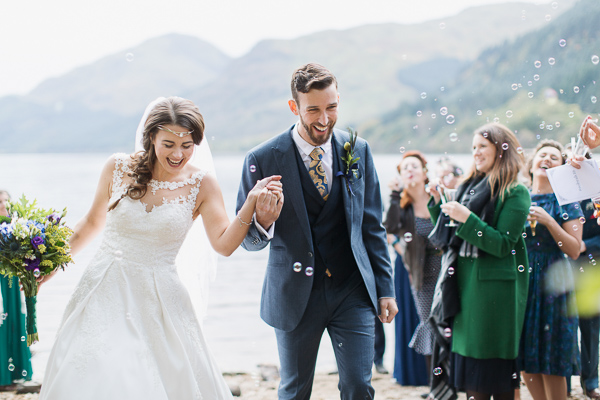 wedding photographer glasgow, bride and groom walk out from ceremony with bubbles outdoors ceremony near glasgow