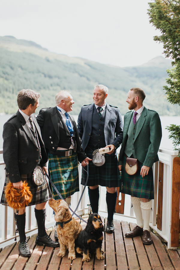 groom with groomsmen and dogs