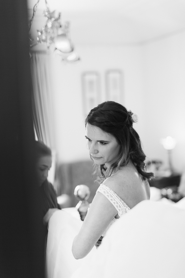 bride puting her wedding dress