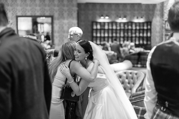 bride meeting evenieng guests at cameron house bar