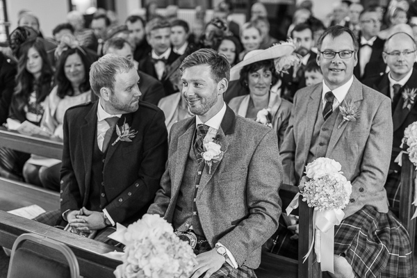 happy groom waiting at the church in bearsden 