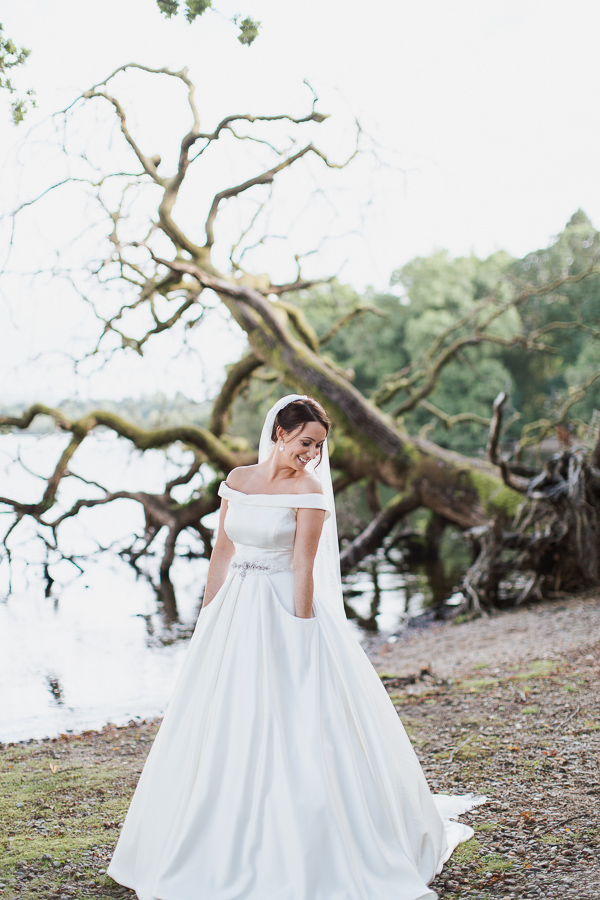 bride with her hands in pockets in dress wedding near glasgow
